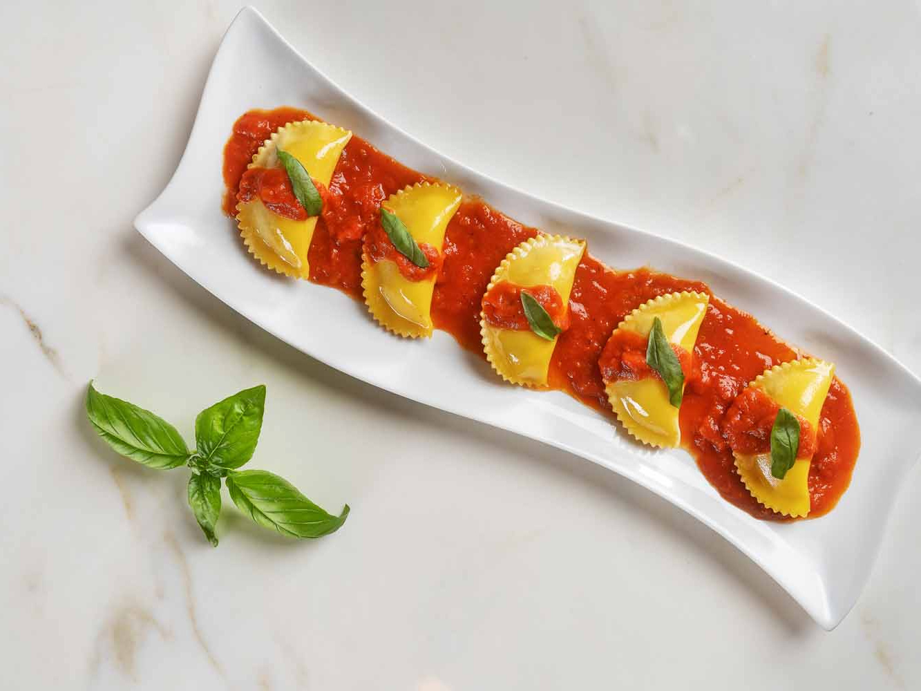 Ravioli with white truffle marinara sauce