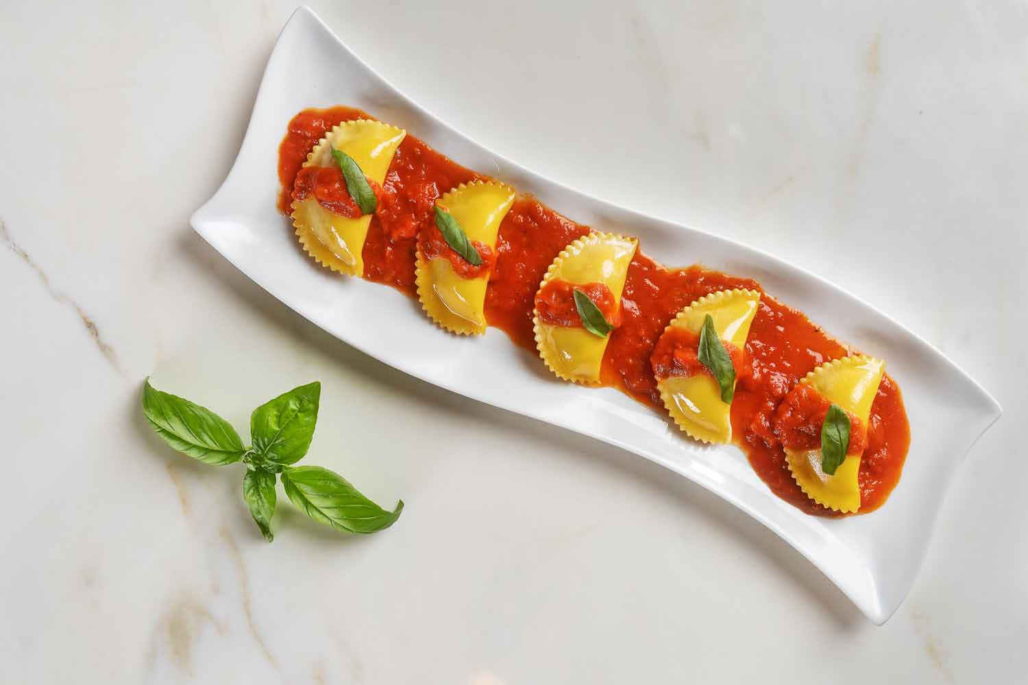 Ravioli with white truffle marinara sauce