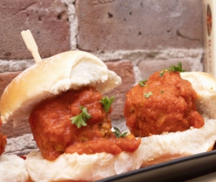 Meatball sliders with tomato sauce and cheese