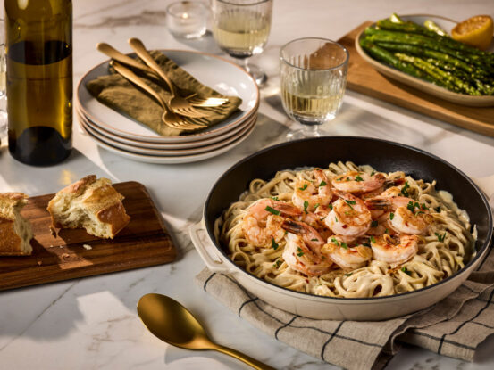 Rao's Alfredo Linguine with Sautéed Shrimp, featuring tender shrimp served over linguine pasta coated in a creamy Alfredo sauce and garnished with fresh herbs.