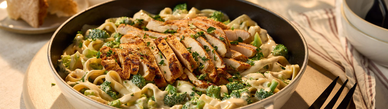 Rao’s Chicken Broccoli Alfredo Fettuccine featuring fettuccine pasta tossed in creamy Alfredo sauce with grilled chicken and broccoli florets.